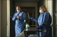  ?? ALFRED-WEGENER-INSTITUT VIA AP ?? Nina Machner, right, holds a COVID-19test swab May 6 as colleague Tim Heitland puts on gloves, before testing a MOSAiC scientist, in Bremerhave­n, Germany.