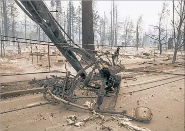  ?? Brian van der Brug Los Angeles Times ?? POWER POLES and lines are burned in the Hidden Valley area of Santa Rosa, Calif, where many homes were destroyed. Fire crews were dispatched to at least 10 spots in Sonoma County in response to reports of sparking electrical wires and exploding...