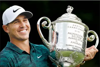  ?? AP/BRYNN ANDERSON ?? Brooks Koepka holds the Wanamaker Trophy after winning the PGA Championsh­ip on Sunday at Bellerive Country Club in St. Louis. Koepka won his second major of the year and third overall. He won the U.S. Open in June.
