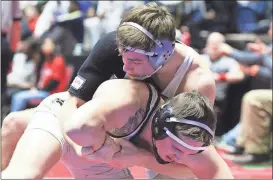  ??  ?? Ridgeland’s Jacob Mariakis (left) takes Troup’s Chase Seals to his back early in the first period of their state championsh­ip match, while Gordon Lee’s Braden Jarvis (right) wraps up Commerce’s Braxton Legg during their title bout. Both Walker County...