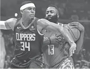  ?? ROBERT HANASHIRO/USA TODAY SPORTS ?? Rockets guard James Harden, colliding with Clippers forward Tobias Harris, says Houston’s success has made the team a target.