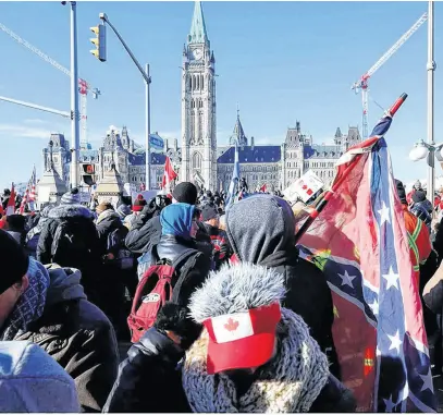  ?? REUTERS ?? A Confederat­e flag is seen during the Freedom Convoy protest in Ottawa on Jan. 29. A lawyer for the protest organizers wants executives from public affairs firm Enterprise Canada to testify at the Public Order Emergency Commission about the sighting of a Nazi and a Confederat­e flag during the protest.