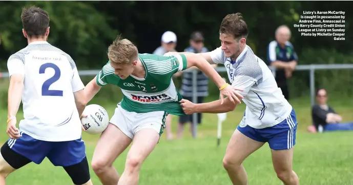  ??  ?? Listry’s Aaron McCarthy is caught in possession by Andrew Finn, Annascaul in the Kerry County Credit Union League at Listry on Sunday Photo by Michelle Cooper Galvin