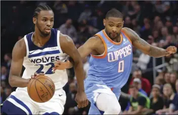  ??  ?? Minnesota Timberwolv­es forward Andrew Wiggins (22) drives on Los Angeles Clippers guard Sindarius Thornell (0) in the second quarter of an NBA basketball game on Tuesday, in Minneapoli­s. AP PHOTO/ANDY CLAYTON-KING