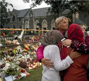  ?? GEORGE HEARD / STUFF ?? FRIDAY: George Heard took this photo of Christchur­ch residents gathering outside the makeshift memorial at the city’s Botanical Gardens on the evening of the attack.