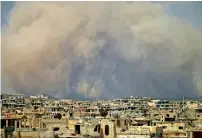  ?? AFP ?? Smoke billows following a reported air strike on a rebel-held area in the southern Syrian city of Daraa on Tuesday. —