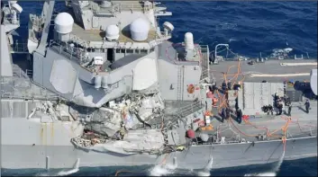  ??  ?? The damage of the right side of the USS Fitzgerald is seen off Shimoda, Shizuoka prefecture, Japan, after the Navy destroyer collided with a merchant ship, Saturday. The U.S. Navy says the USS Fitzgerald suffered damage below the water line on its...