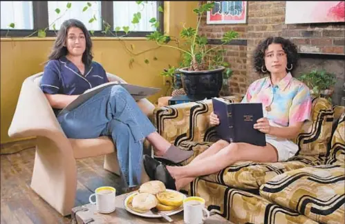  ??  ?? Abbi Jacobson (left) and Ilana Glazer of “Broad City” eat bagels, drink coffee and look at copies of City Charter in public service announceme­nt.