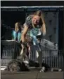  ?? ERIC RISBERG — ASSOCIATED PRESS ?? Shirley Zindler raises the leg of Martha, a Neapolitan Mastiff, during the World’s Ugliest Dog Contest at the Sonoma-Marin Fair Friday, in Petaluma, Calif. Martha was named the winner of the contest.