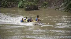  ?? ?? Rescuers use a boat to look for a missing ice cream vendor believed to have drowned in a river in Mambusao, Capiz.
