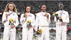  ?? Matthias Hangst / Getty Images ?? Gold medalists Allyson Felix, Athing Mu, Dalilah Muhammad and Sydney McLaughlin of Team United States stand on the podium during the medal ceremony for the women’s 4x400-meter relay at the Olympics on Saturday.