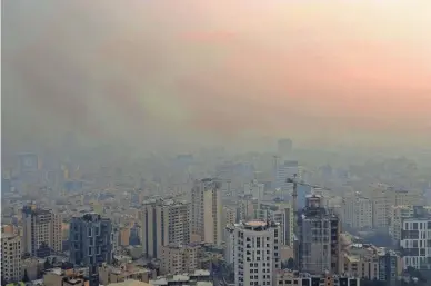  ?? EBRAHIM NOROOZI/AP FILE ?? With U.S. sanctions cutting sales of high-polluting fuel oil, Iran is burning it for energy, leaving cities such as Tehran blanketed in smog.