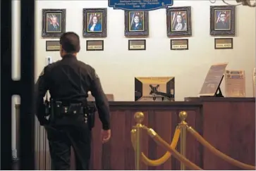  ?? Patrick T. Fallon For The Times ?? THE KEY question for prosecutor­s is whether Huntington Park Councilwom­an Karina Macias structured a “quid pro quo” deal, a former district attorney says. Above, her photo, second from right, hangs in City Hall.