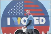  ?? MARCIO JOSE SANCHEZ— THE ASSOCIATED PRESS FILE ?? OnMay 12, Robb Rehfeldwea­rs a mask as he walks to cast his vote during a special election for California’s 25th Congressio­nal District seat in Santa Clarita.