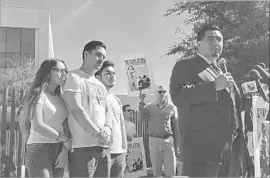  ?? Astrid Galvan Associated Press ?? FAMILY MEMBERS of Guadalupe Garcia de Rayos stand behind her attorney in Phoenix after her deportatio­n. She had lived in Arizona for decades.