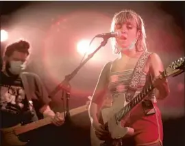  ?? Scott Olson Getty Images ?? BEACH BUNNY’S Anthony Vaccaro and Lili Trifilio do a sound check before a gig at an empty venue in July. The Chicago show was streamed for paying guests.