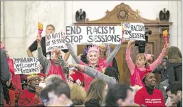  ?? AL DRAGO / NEW YORK TIMES ?? Desiree A. Fairooz, 61, of Bluemont, Va., is partially obscured by a sign at center during a Code Pink protest Jan. 10 at Jeff Sessions’ confirmati­on hearing for attorney general. Fairooz said that all she did was break out in laughter when a senator...