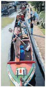  ?? PHOTO: JOE BAILEY ?? Shipshape and Braunston fashion: The wooden butty Raymond following its recent overhaul in the large dry dock at Braunston Marina. Volunteer Will Hewitt is pictured giving it a final clean before the presentati­on parade.