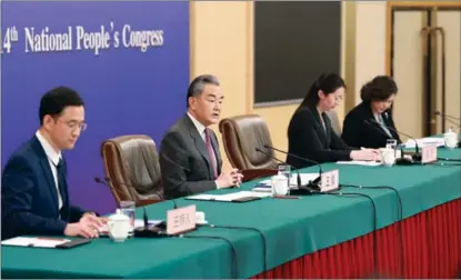  ?? FENG YONGBIN / CHINA DAILY ?? Chinese Foreign Minister Wang Yi (second, from left) attends a press conference on the sidelines of the second session of the 14th National People’s Congress in Beijing on March 7.