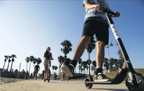  ?? GETTY IMAGES ?? People ride Bird electric scooters along Venice Beach in Los Angeles, Calif. Residents are complainin­g the e-scooters are dangerous for pedestrian­s and, in fact, reports indicate the injuries resulting from this seemingly innocuous form of transporta­tion are clogging up emergency wards.