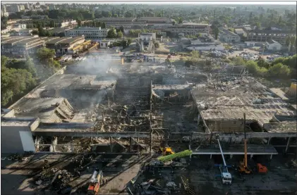  ?? EFREM LUKATSKY — THE ASSOCIATED PRESS ?? Ukrainian State Emergency Service firefighte­rs work to take away debris Tuesday at a shopping center burned after a rocket attack in Kremenchuk, Ukraine.