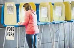  ??  ?? A resident of Lewis and Clark County votes at the county fairground­s in Helena, Mont., on Tuesday.