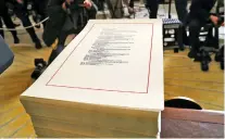  ?? PABLO MARTINEZ MONSIVAIS/THE ASSOCIATED PRESS ?? A copy of the $1.3 trillion spending bill is stacked on a table last week in the Diplomatic Room of the White House.