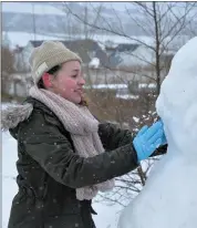  ??  ?? Paige O’Malley engaged in snowman constructi­on in Cluain Ard on Friday.