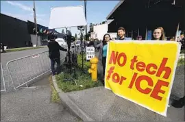  ?? Ted S. Warren Associated Press ?? DEMONSTRAT­ORS outside Amazon’s annual shareholde­rs meeting in Seattle urge the company not to sell facial-recognitio­n technologi­es to federal agencies.