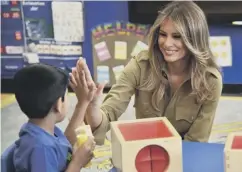  ??  ?? 0 First Lady Melania Trump jokes with a schoolboy in Riyadh