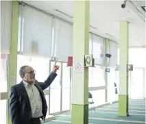  ?? ALICE CHICHE/GETTY IMAGES ?? Mohamed Labidi, president of the Centre Culturel Islamique de Québec, points at a surveillan­ce camera inside the prayer room where the Quebec mosque attack took place on Jan. 29.