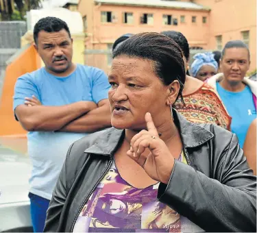  ?? Picture: EUGENE COETZEE ?? DESPERATE MEASURES: Gamble Street High School governing body chairwoman Marelyn Blom with parents blocking the main gate to the school yesterday