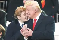  ?? PABLO MARTINEZ MONSIVAIS / ASSOCIATED PRESS ?? President Donald Trump shares a joke with his son Barron as they watch the 58th presidenti­al inaugurati­on parade in Washington.