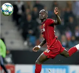  ?? GETTY IMAGES ?? Liverpool striker Sadio Mane scores his side’s third goal in the 4-1 win over Genk.