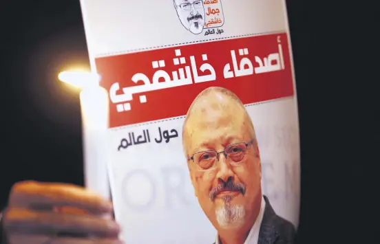  ??  ?? A demonstrat­or holds a poster with a picture of Saudi journalist Jamal Khashoggi outside Saudi Arabia's Consulate in Istanbul, Oct. 25.