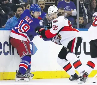  ?? BRUCE BENNETT/GETTY IMAGES ?? The Rangers’ Jesper Fast lays a hit on Senators captain Erik Karlsson, a common theme during Game 4 of their series Thursday in New York. Karlsson was forced to leave after two periods.