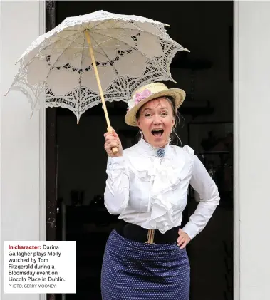  ?? PHOTO: GERRY MOONEY ?? In character: Darina Gallagher plays Molly watched by Tom Fitzgerald during a Bloomsday event on Lincoln Place in Dublin.