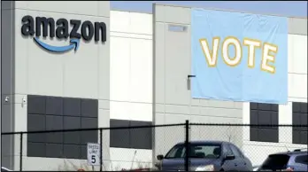  ?? ASSOCIATED PRESS ?? A banner encouragin­g workers to vote in labor balloting is shown at an Amazon warehouse in Bessemer, Ala., on Tuesday.