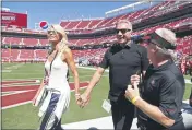  ?? TONY AVELAR — THE ASSOCIATED PRESS FILE ?? Joe Montana and hiswife, left, Jennifer walk onto the field at Levi’s Stadium before a Sept. 16, 2018, NFL game between the San Francisco 49ers and the Detroit Lions in Santa Clara. Montana and hiswife confronted a home intruder who attempted to kidnap their grandchild.