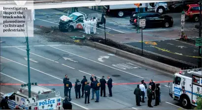  ?? PHOTO: GETTY IMAGES ?? Investigat­ors inspect the truck which plowed into cyclists and pedestrian­s