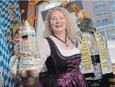  ?? PETER LEE WATERLOO REGION RECORD ?? Margo Jones, president of Oktoberfes­t Inc., holds a beer stein inside the Oktoberfes­t store at Benton and Charles streets in downtown Kitchener.