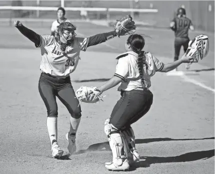  ?? SARAH PHIPPS/THE OKLAHOMAN ?? Southmoore’s Brinly Maples, left, and Lexi Hernandez celebrate after beating Mustang 5-1 on Friday at the USA Softball Hall of Fame Complex.