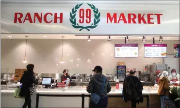  ?? PHOTOS BY ARIC CRABB — STAFF PHOTOGRAPH­ER ?? Customers wait in line at the 99Ranch Market mall-access deli counter inside the Westfield Oakridge shopping center on Tuesday. The new grocery store is the chain's first new-concept store in California.