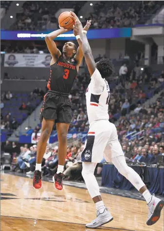  ?? Jessica Hill / Associated Press ?? Houston's Armoni Brooks makes a basket as UConn’s Sidney Wilson, right, defends during the first half Thursday in Hartford.