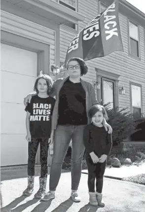  ?? FRED SQUILLANTE/COLUMBUS DISPATCH ?? Pint Size Protesters gave Dublin mom Lily Cunningham, center, a way to educate her daughters, Zoe, 8, left, and Olive, 4, about the police brutality, recent unrest, and racial justice unfolding around them.