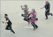  ?? AP ?? Riot police chase a protester in Bangkok on Wednesday who was rallying against the Thai government’s handling of Covid-19.