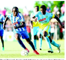  ?? RICARDO MAKYN ?? Mount Pleasant’s Kesslon Hall (left) tries to get away from Waterhouse captain Keithy Simpson during their Red Stripe Premier League encounter at Drax Hall on Sunday, September 23, 2018.
