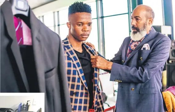  ??  ?? ATTENTION TO DETAIL. Abu-Baker Frizlaar finds the perfect fit for Bongani Mbuli.