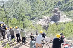  ??  ?? ABOVE Observers witness a controlled explosion staged as part of what North Korea says was the demolition of its nuclear test centre earlier this month.