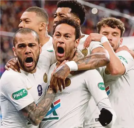  ?? REUTERS PIC ?? PSG’s Dani Alves (left) celebrates with Neymar (centre) and teammates after scoring their first goal against Rennes in Saint-Denis on Saturday.